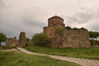 View of the historic Jvari Monastery stone building nestled in the Georgian landscape