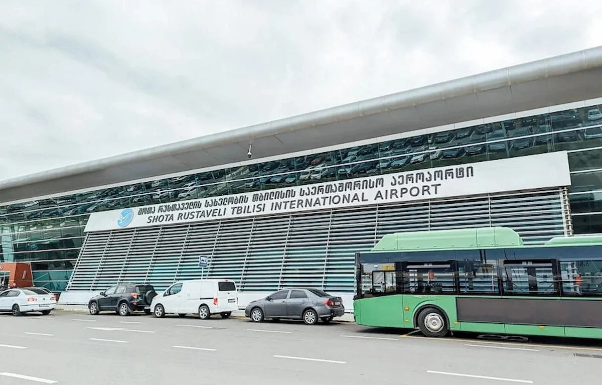 Shota Rustaveli Tbilisi International Airport (TBS) terminal exterior view from the pickup area where our private transfers wait