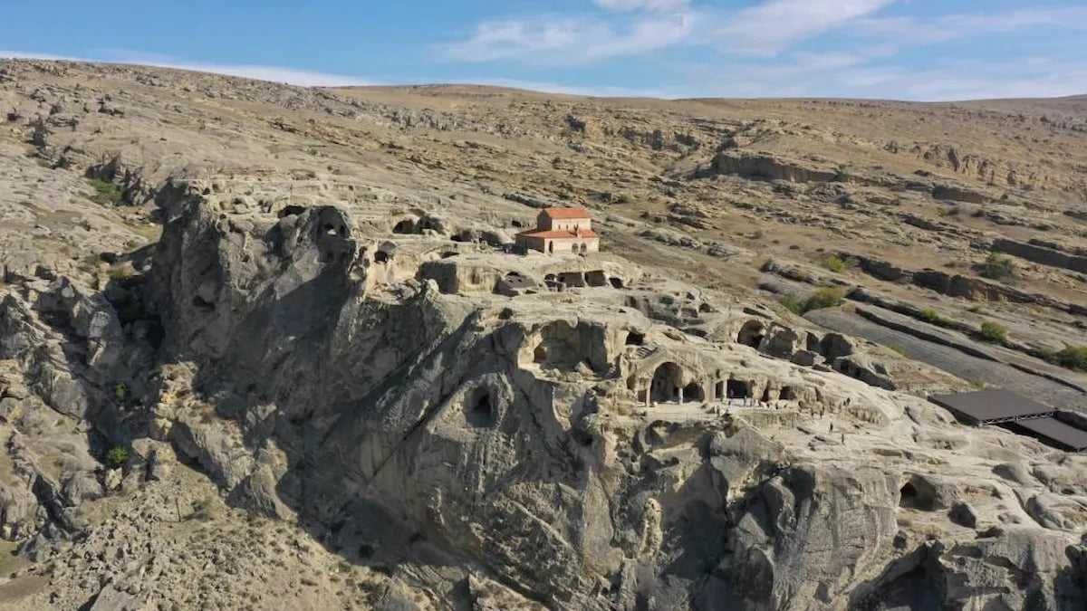 Aerial overview of the expansive ancient rock-hewn cave city of Uplistsikhe in Georgia