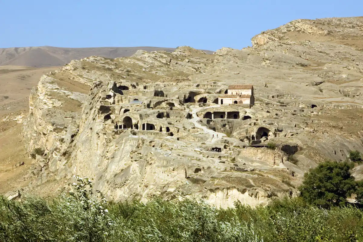 Wide shot of the dramatic rock structures and ancient cave dwellings of Uplistsikhe