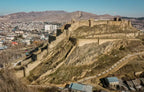 Panoramic view of the medieval Gori Fortress ruins set against a backdrop of Georgian mountain landscapes