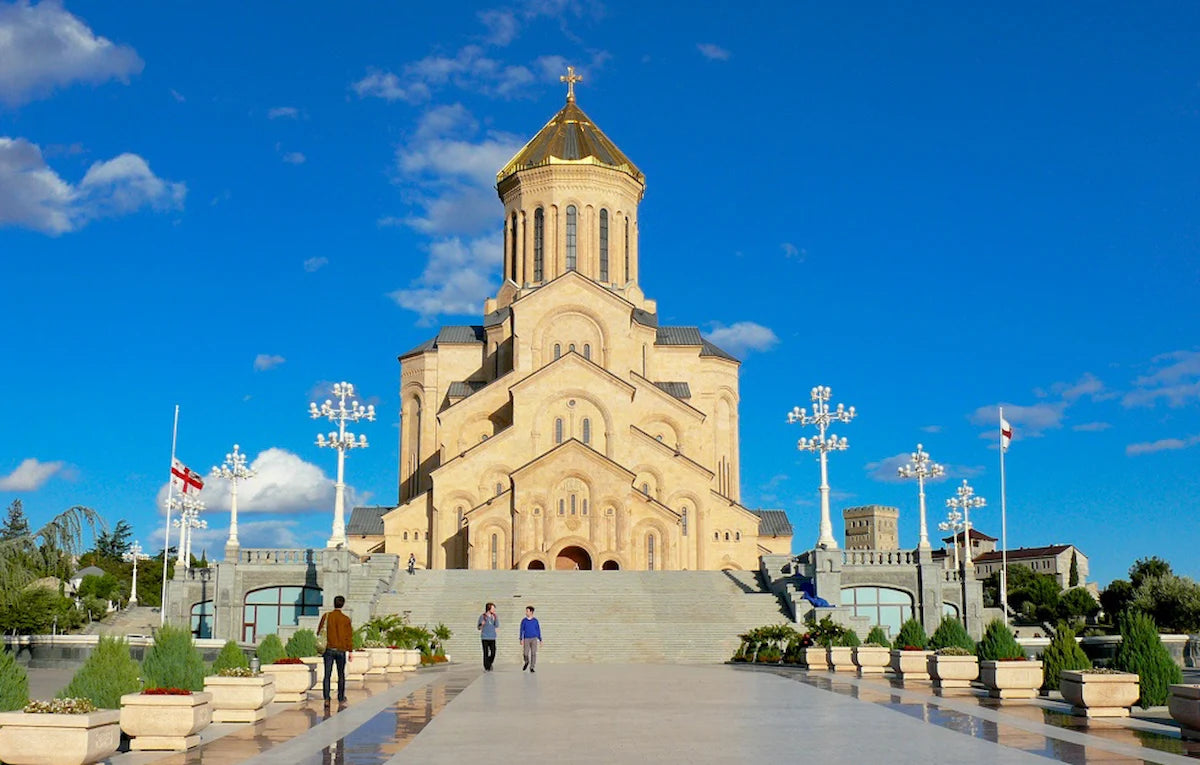 The Holy Trinity Cathedral of Tbilisi (Sameba) with its golden dome under a blue sky in Georgia