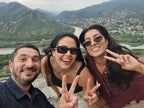 Happy travelers from London taking a selfie with the stunning landscape view from Jvari Monastery.