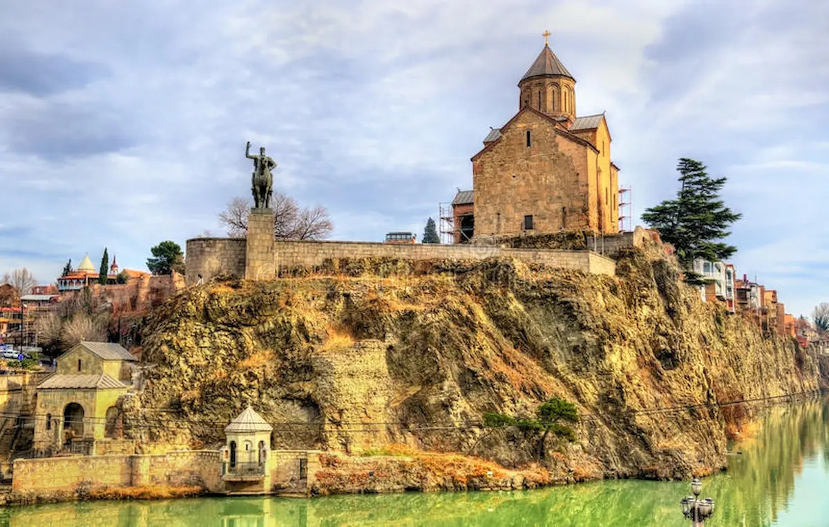 Historic Metekhi Church and the monument of King Vakhtang Gorgasali on the cliff overlooking the Mtkvari River in Tbilisi, Georgia