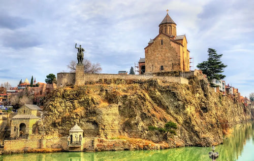 Historic Metekhi Church and the monument of King Vakhtang Gorgasali on the cliff overlooking the Mtkvari River in Tbilisi, Georgia