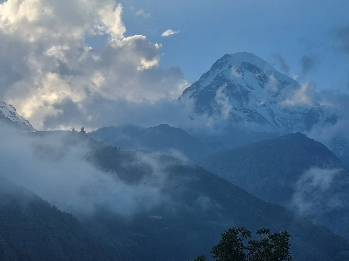 Mount Kazbek snow peak and Caucasus mountain range panoramic landscape photography in Georgia