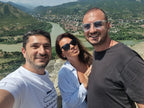 Tour guide and guests from France taking a selfie with the beautiful Mtskheta river valley view from Jvari.