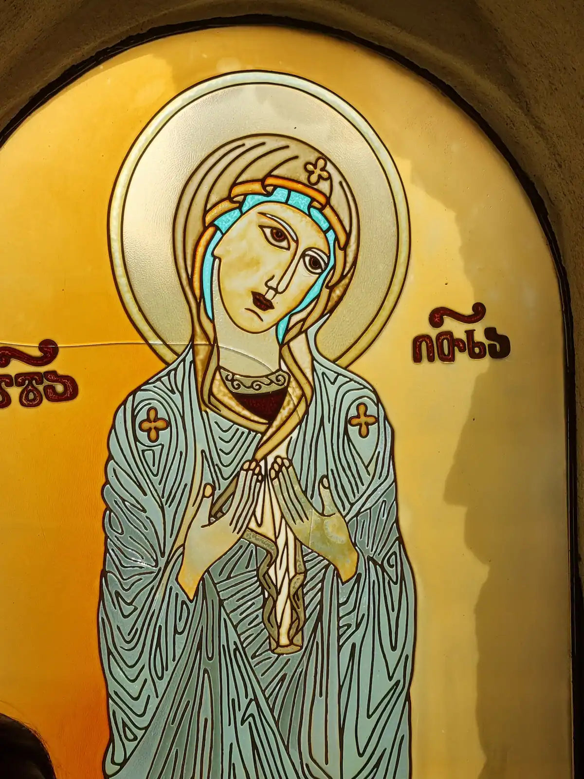 Detailed close-up of a vibrant Georgian Orthodox icon, featuring Saint Nino, discovered during a private tour of the Dzama Valley monasteries.