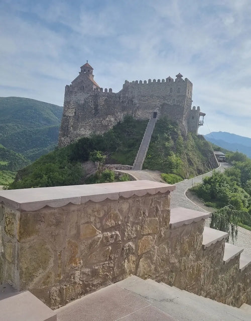 A breathtaking view of the Mzovreti fortress and monastery complex in the heart of the Dzama Valley, a highlight of our one-day private tour from Tbilisi.