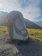 Unique stone head sculpture and cultural monument landmark along a scenic mountain tour route in Georgia.