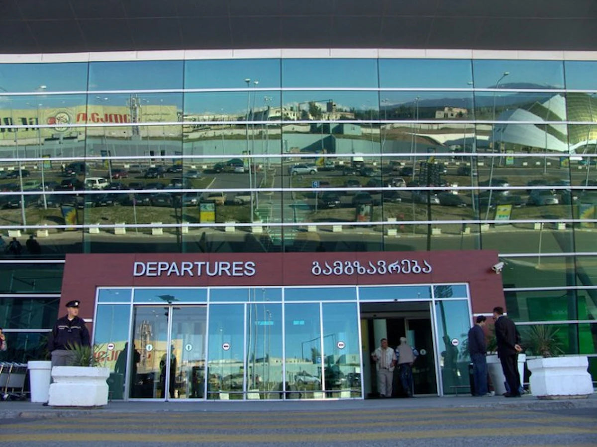 Tbilisi International Airport departures entrance for scheduled flight drop-offs and private airport transfers from Tbilisi city center.